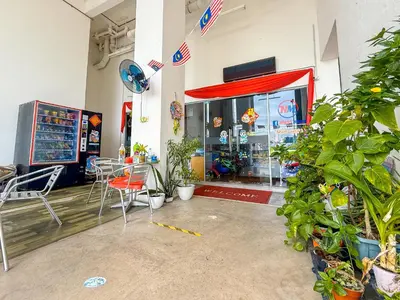a store with tables and chairs in front of a store at Taiping City View 3BR Condo near Lake Garden with Sunset View & Swimming Pool, Free Netflix WiFi in Taiping