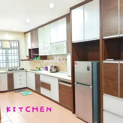 a kitchen with white cabinets and a refrigerator at Muslim Suite Home @ Airport Bayan Lepas Penang in Bayan Lepas