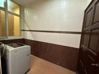 a bathroom with a washing machine and a window at Muslim Suite Home @ Airport Bayan Lepas Penang in Bayan Lepas