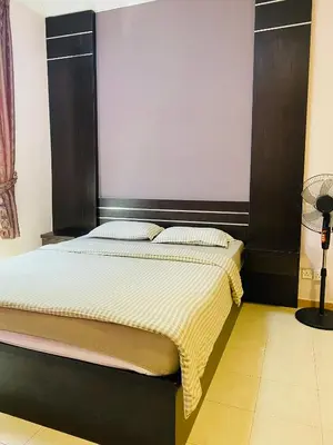 a bed with a black headboard in a room at Qaseh Homestay Cameron Highlands 3 in Brinchang