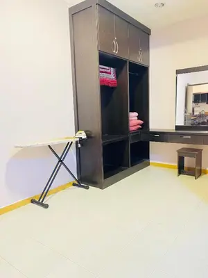a room with a closet with a mirror and a table at Qaseh Homestay Cameron Highlands 3 in Brinchang