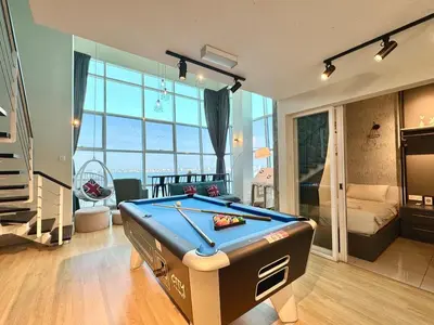 a living room with a pool table in the middle at Maritime Suite #Full Seaview #Pool Table #Hot Water Dispenser #Kids friendly #Georgetown #6pax #2BR2bath #Private host in Jelutong