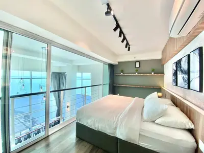 a bedroom with a bed and a balcony at Maritime Suite #Full Seaview #Pool Table #Hot Water Dispenser #Kids friendly #Georgetown #6pax #2BR2bath #Private host in Jelutong