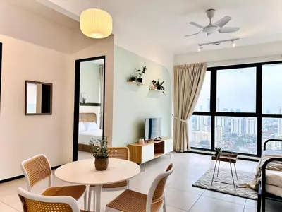 a living room with a table and chairs at Urban Suite Cozy Family Homestay at Georgetown by URBAN STAYCATION HENG LOD LUXE in Jelutong