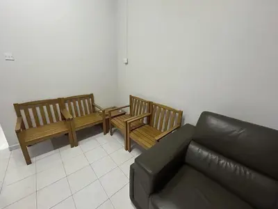 a living room with two benches and a couch at Muhibbah Homestay in Sungai Siput