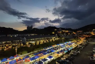 a city with a bunch of cars parked in a parking lot at G Residence - 2R2B Barrington Night Market (2) in Brinchang