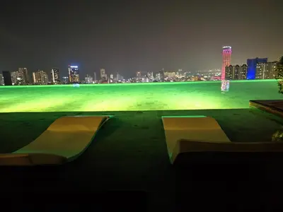 a park with two benches and a city at night at SkyPool 2BR 9pax Premium Suite@Beacon @Georgetown @Penang in George Town
