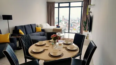 a living room with a table and chairs and a couch at SkyPool 2BR 9pax Premium Suite@Beacon @Georgetown @Penang in George Town