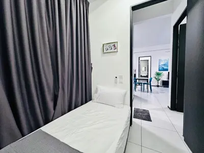 a bed in a room with a curtain at Urban Suites Homestay WL COSY in Jelutong