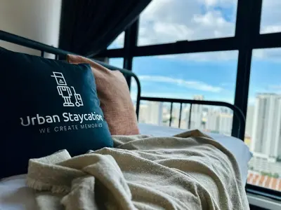 a bed with a pillow in a room with a window at Urban Suites Homestay WL COSY in Jelutong