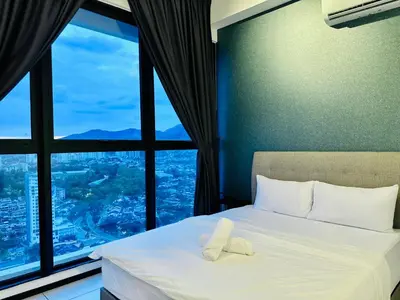 a hotel room with a bed with a large window at Urban Suites Homestay WL COSY in Jelutong