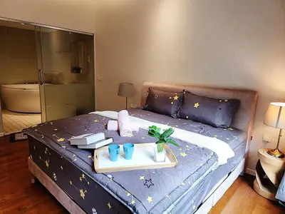 a bedroom with a bed with a tray on it at IPOH All Suite Resort, Jalan Haven, Persiaran Lembah Perpaduan, Ipoh in Ipoh