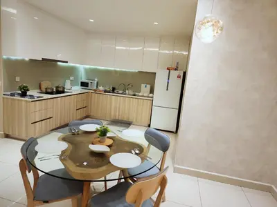 a kitchen with a table and chairs in a kitchen at IPOH All Suite Resort, Jalan Haven, Persiaran Lembah Perpaduan, Ipoh in Ipoh