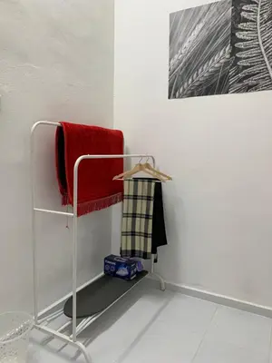 a towel rack with a red towel on a wall at Rezeki indah Hstay self check in in Bukit Mertajam