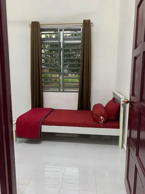 a small bed in a room with a window at Rezeki indah Hstay self check in in Bukit Mertajam