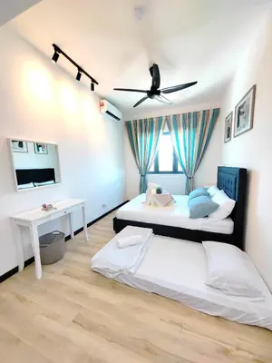 a bedroom with two beds and a ceiling fan at Monstera Meritus Homestay - Penang Butterworth Prai 1-8PAX in Perai