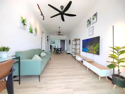 a living room with a blue couch and a ceiling fan at Monstera Meritus Homestay - Penang Butterworth Prai 1-8PAX in Perai