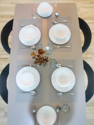 a table with white plates and silverware on it at Monstera Meritus Homestay - Penang Butterworth Prai 1-8PAX in Perai