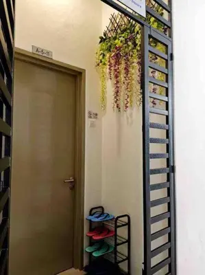 a room with a rack of shoes next to a door at Cameron Highlands, The Breeze @ Barrington Square in Brinchang