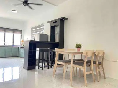 a kitchen with a table and chairs in a room at Diamond Bay Homestay in Teluk Intan