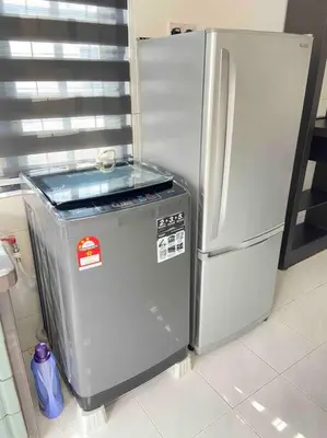 a refrigerator and a trash can in a kitchen at Diamond Bay Homestay in Teluk Intan