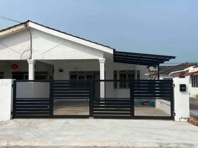 a house with a gate in front of it at Diamond Bay Homestay in Teluk Intan