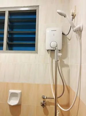 a shower head in a bathroom with a window at Homestay 2 @Taman Teluk Intan in Teluk Intan