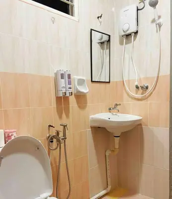 a bathroom with a toilet and a sink at Homestay 2 @Taman Teluk Intan in Teluk Intan