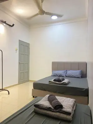 a bedroom with two beds and a ceiling at Homestay 2 @Taman Teluk Intan in Teluk Intan