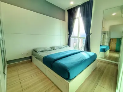 a bedroom with a bed with blue sheets and a window at Awesome Suites 1, Netflix, Georgetown in Jelutong