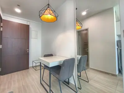 a dining room with a white table and chairs at Awesome Suites 1, Netflix, Georgetown in Jelutong