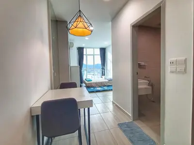 a room with a table and chairs and a bathroom at Awesome Suites 1, Netflix, Georgetown in Jelutong