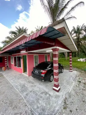 a car parked in front of a pink house at Rumah Comel in Kampung Degong