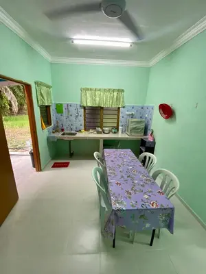 a dining room with a purple table and chairs at Rumah Comel in Kampung Degong