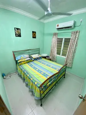 a bedroom with a bed in a room at Rumah Comel in Kampung Degong