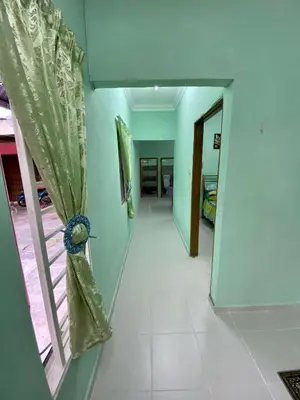 a hallway with a window and a mirror at Rumah Comel in Kampung Degong