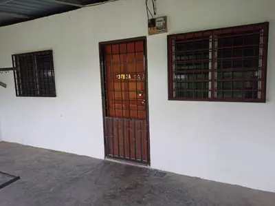 two doors on the side of a white building at TokBi Homestay Gerik in Gerik