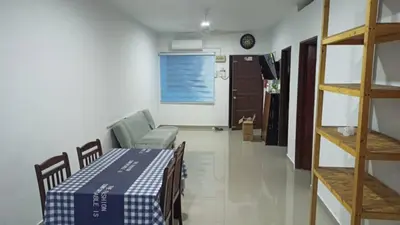 a room with a table and a couch in a room at TokBi Homestay Gerik in Gerik