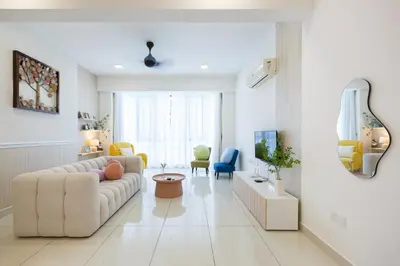 a white living room with a white couch and chairs at The Jazz Serviced Suites in Tanjong Tokong