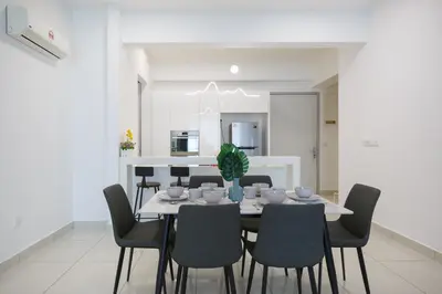 a dining room with a table and chairs at The Jazz Serviced Suites in Tanjong Tokong