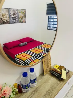 a mirror on a shelf with a bed in a room at Al Ghazali Homestay in Seri Iskandar