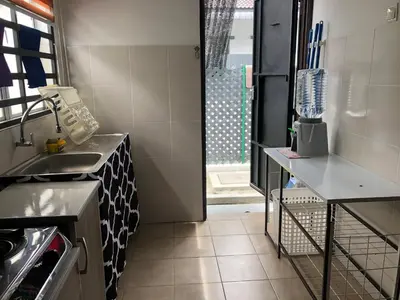 a small kitchen with a sink and a counter at Al Ghazali Homestay in Seri Iskandar