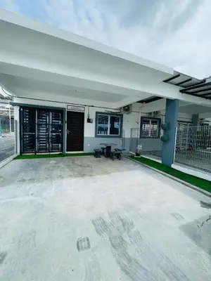 an empty parking lot with a building with a garage at Al Ghazali Homestay in Seri Iskandar