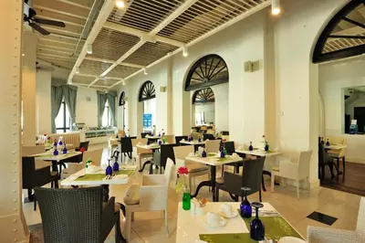 a restaurant with tables and chairs in a room at Royale Chulan Penang in George Town