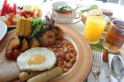 a plate of breakfast food with an egg and beans at Royale Chulan Penang in George Town