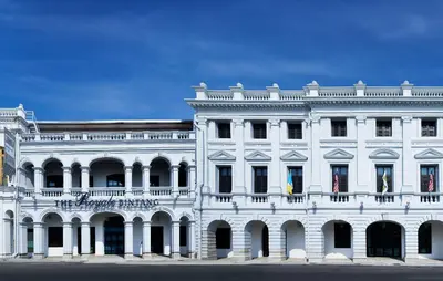 a white building with a balcony on top of it at Royale Chulan Penang in George Town