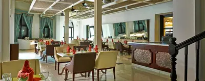 a dining room with tables and chairs in a restaurant at Royale Chulan Penang in George Town