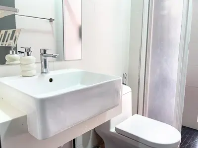 a white bathroom with a sink and a toilet at Beacon Executive Suite with SkyPool 3BR 8pax Georgetown Penang in Georgetown