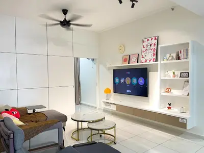 a living room with a couch and a tv at Beacon Executive Suite with SkyPool 3BR 8pax Georgetown Penang in Georgetown