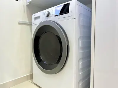 a white washing machine in a white laundry room at Beacon Executive Suite with SkyPool 3BR 8pax Georgetown Penang in Georgetown